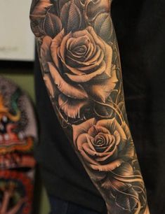 a man's arm with roses on it