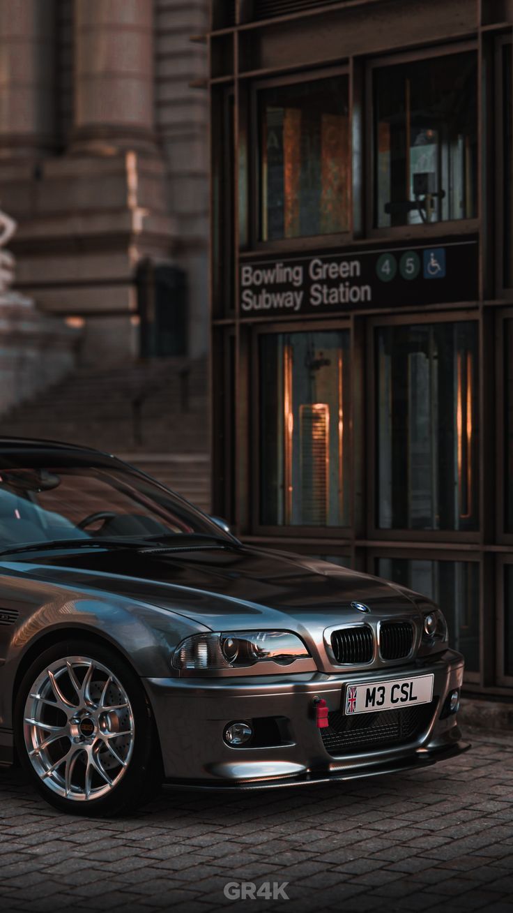 a silver car parked in front of a building