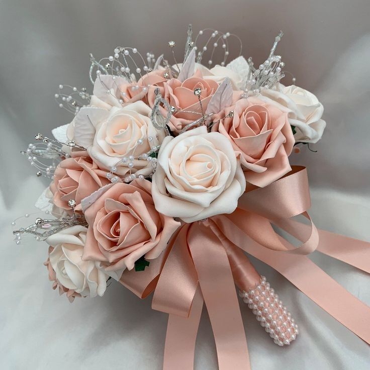 a bridal bouquet with pink roses and pearls