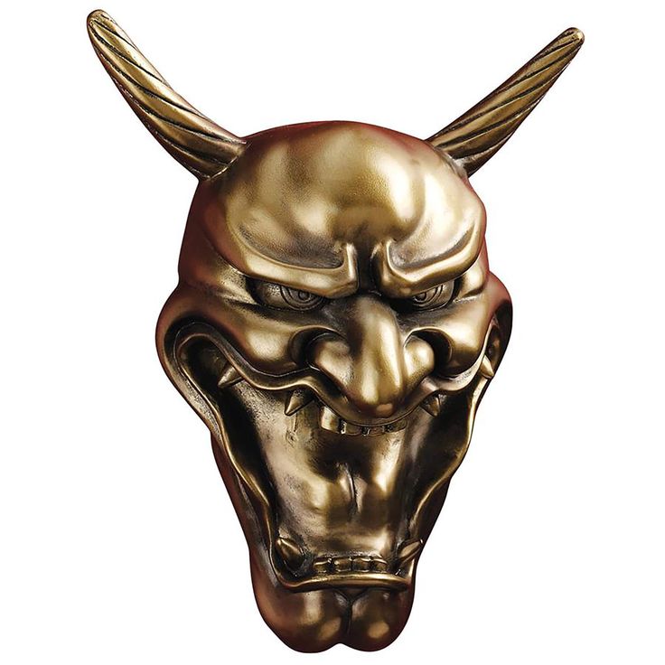 a gold mask with horns and fangs on it's face is seen against a white background