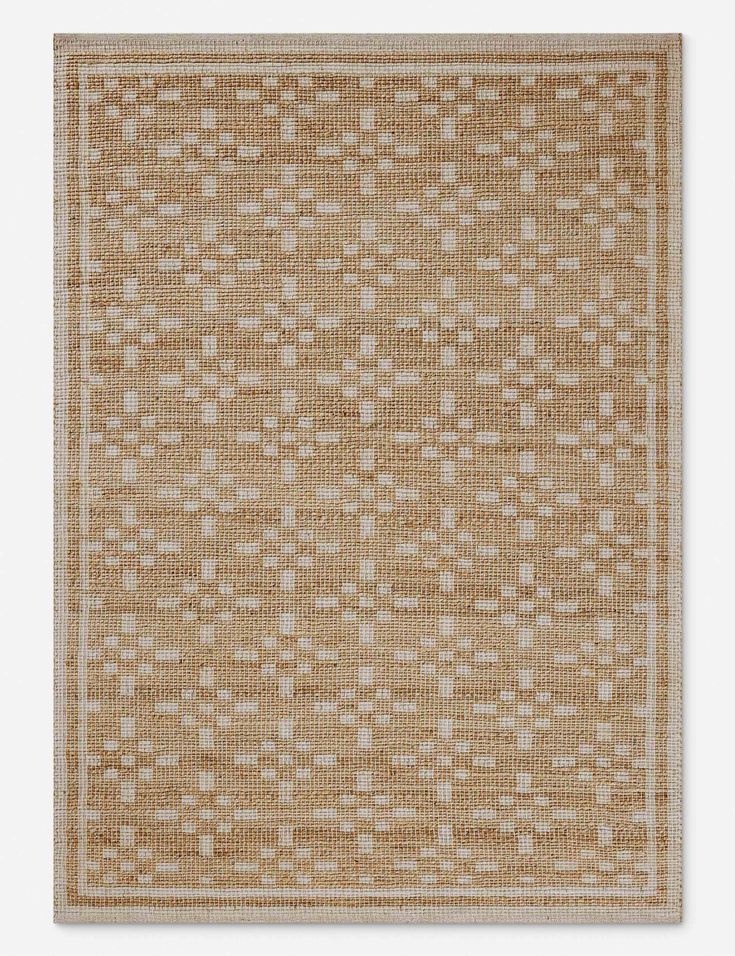 a beige rug with white squares on it