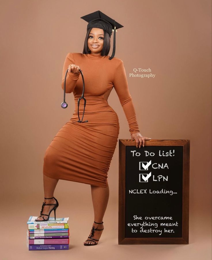 a woman in a graduation cap and gown holding a sign