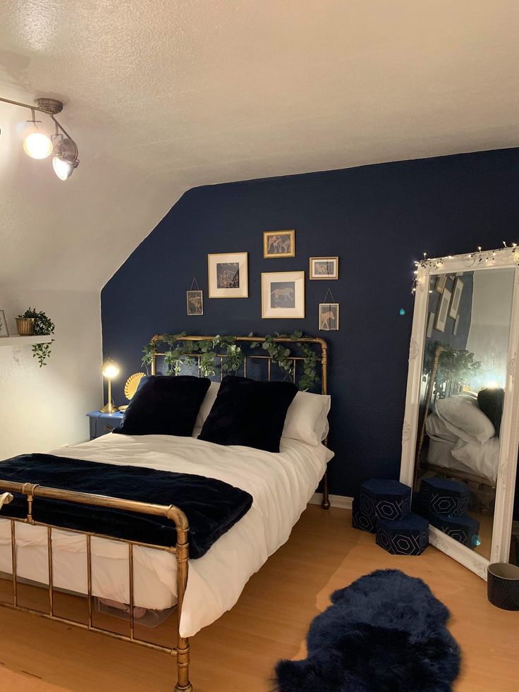 a bed room with a neatly made bed and blue walls