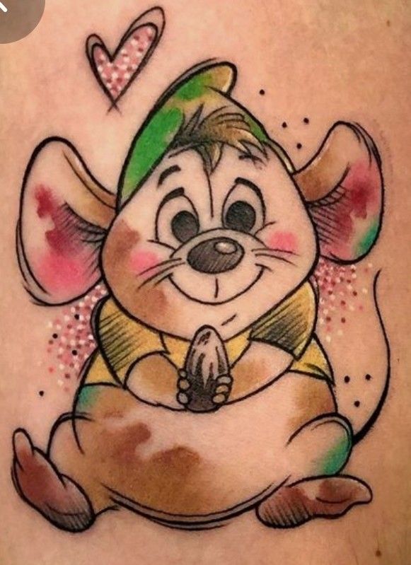 a cartoon mouse tattoo on the back of a woman's leg, with hearts in the background