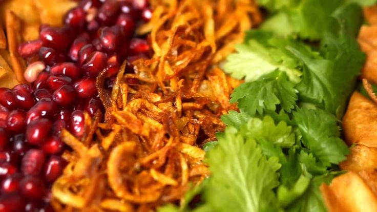 some food is laying out on a plate with lettuce and pomegranates