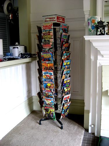 a magazine rack sitting in the corner of a living room next to a fire place