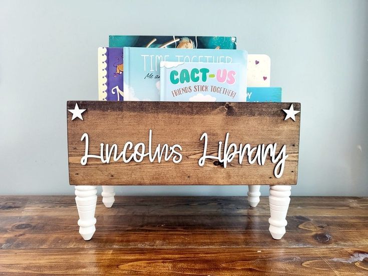 a wooden sign that says lincoln's library on it sitting on a wood table