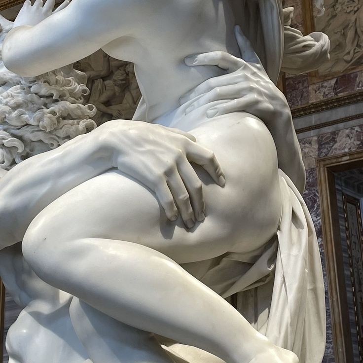 there is a white statue that looks like a woman with her hands on her chest