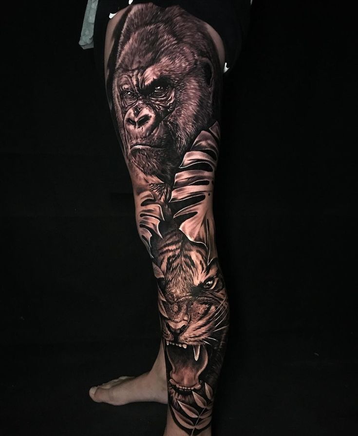 a man's leg with tattoos on it that has a gorilla and tiger on it