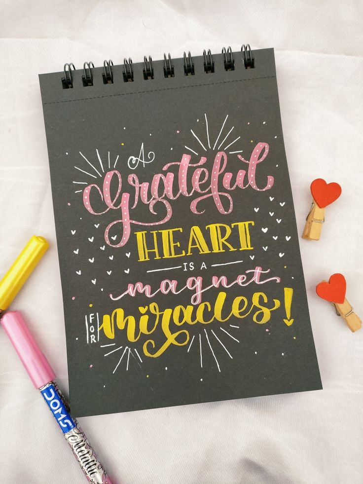 a notepad with the words grateful heart is magnets on it next to some crayons