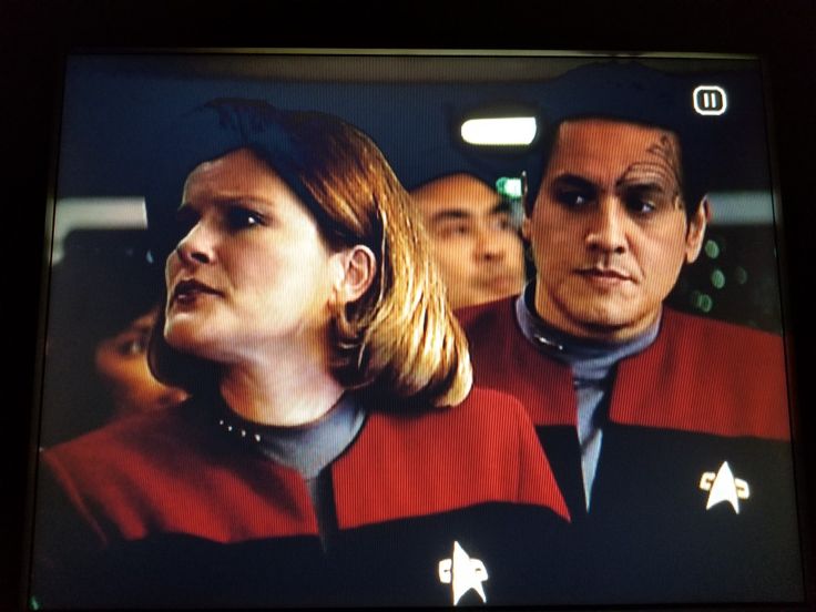 two people in star trek uniforms on a television screen