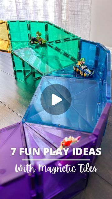 an upside down toy car sitting on top of a wooden floor next to other toys