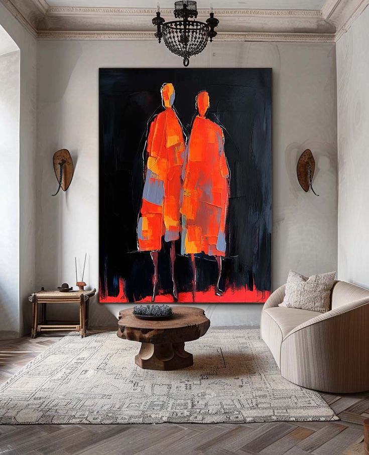 two people standing in front of a large painting on the wall above a coffee table