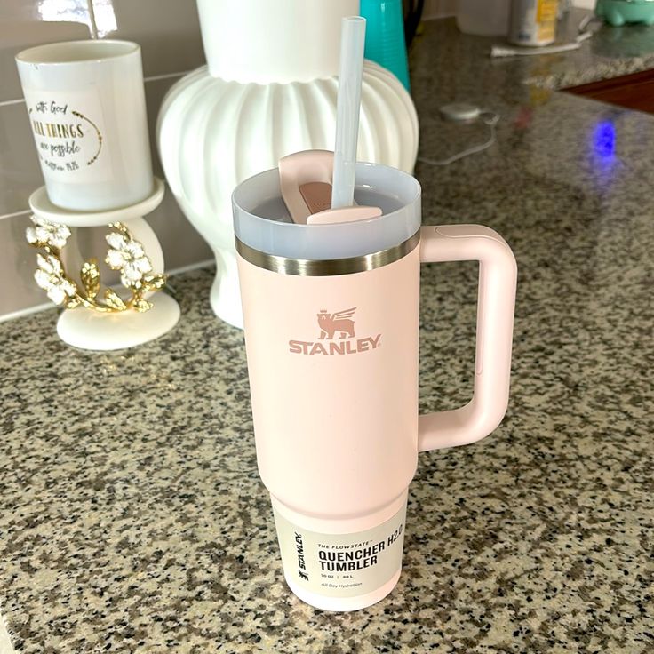 a pink starbucks cup sitting on top of a counter