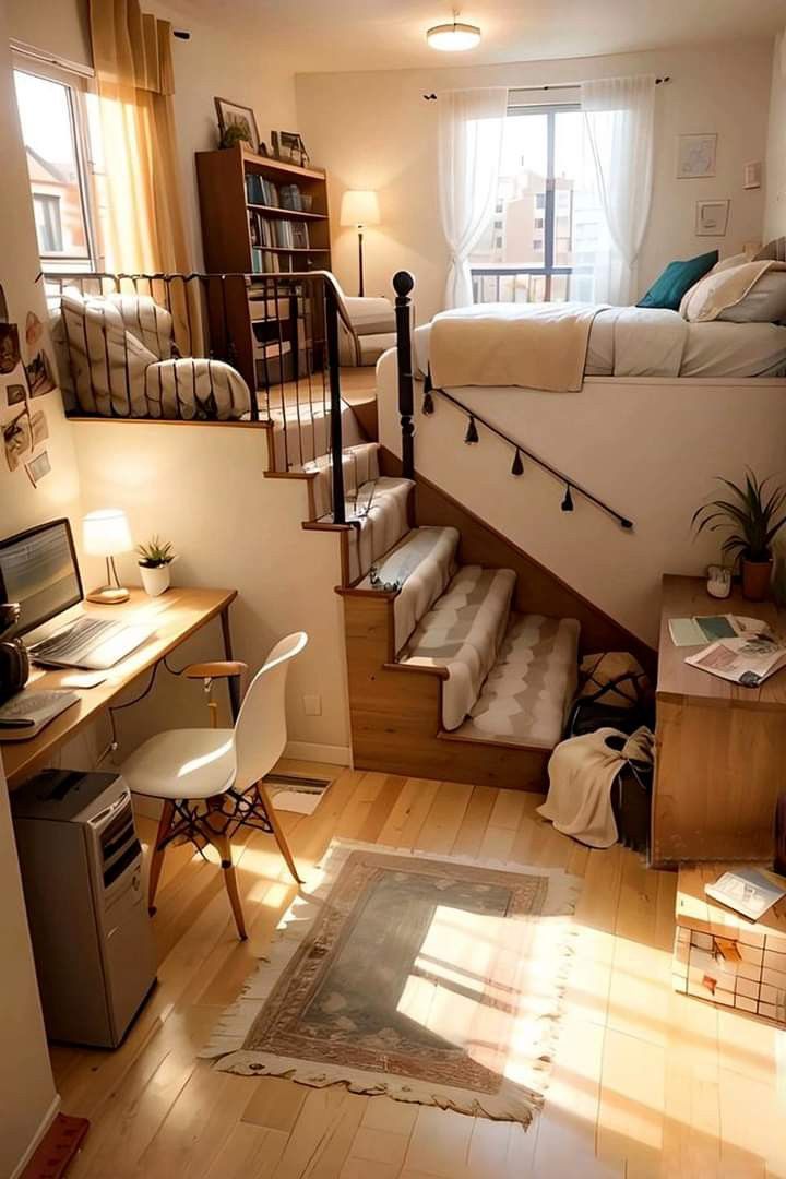 a bedroom with stairs leading up to a loft bed and desk in front of a window