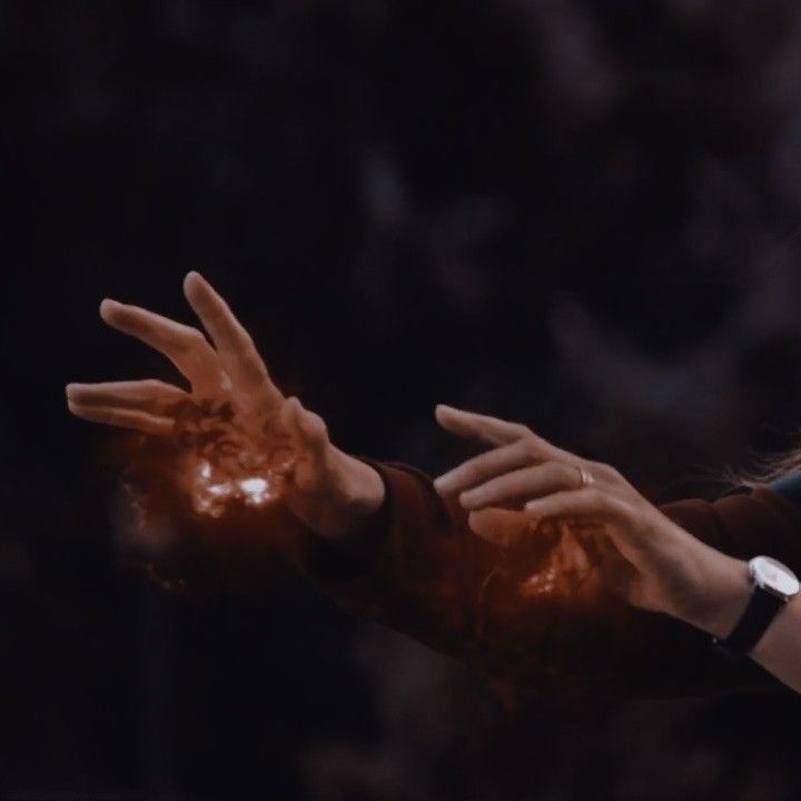 a woman is holding out her hand with orange powder on it and wearing a watch