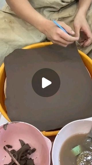 a person holding a spoon in front of two bowls filled with food