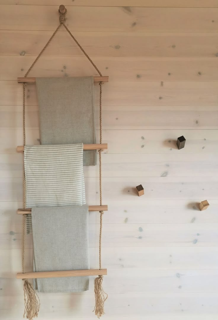 two towels are hanging on a wooden rack