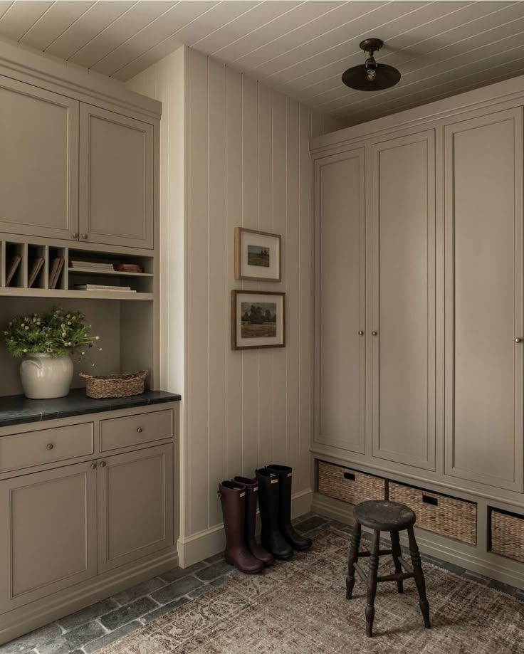 a well - lit room with lots of cabinets and stools on the floor in front of it