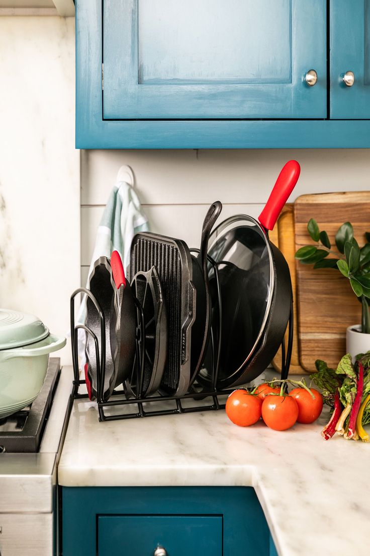 This versatile cookware organizer is designed to hold Lodge Cast Iron’s most popular pieces. It is designed to be placed on a counter or in a cabinet, and can be used for vertical or horizontal storage so you can make the most of whatever space you have to use. Lodge Cast Iron 9.69-in W x 15.5-in H x 11.81-in D 5-Tier Freestanding Black Metal Pot and Pan Rack | AW5S Pot And Pan Rack, Cookware Organization, Cabinet Organizers, Pan Rack, Lodge Cast Iron, Cabinets Organization, Pots And Pans, Free Standing, Black Metal