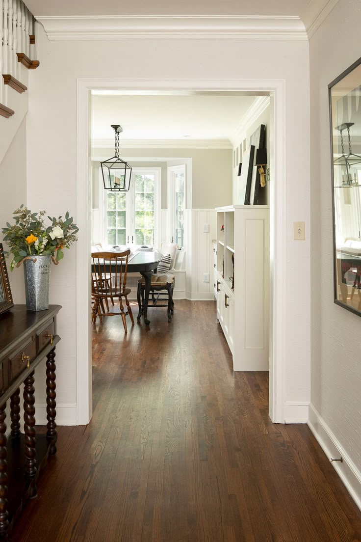 the hallway is clean and ready to be used as a dining room or living room