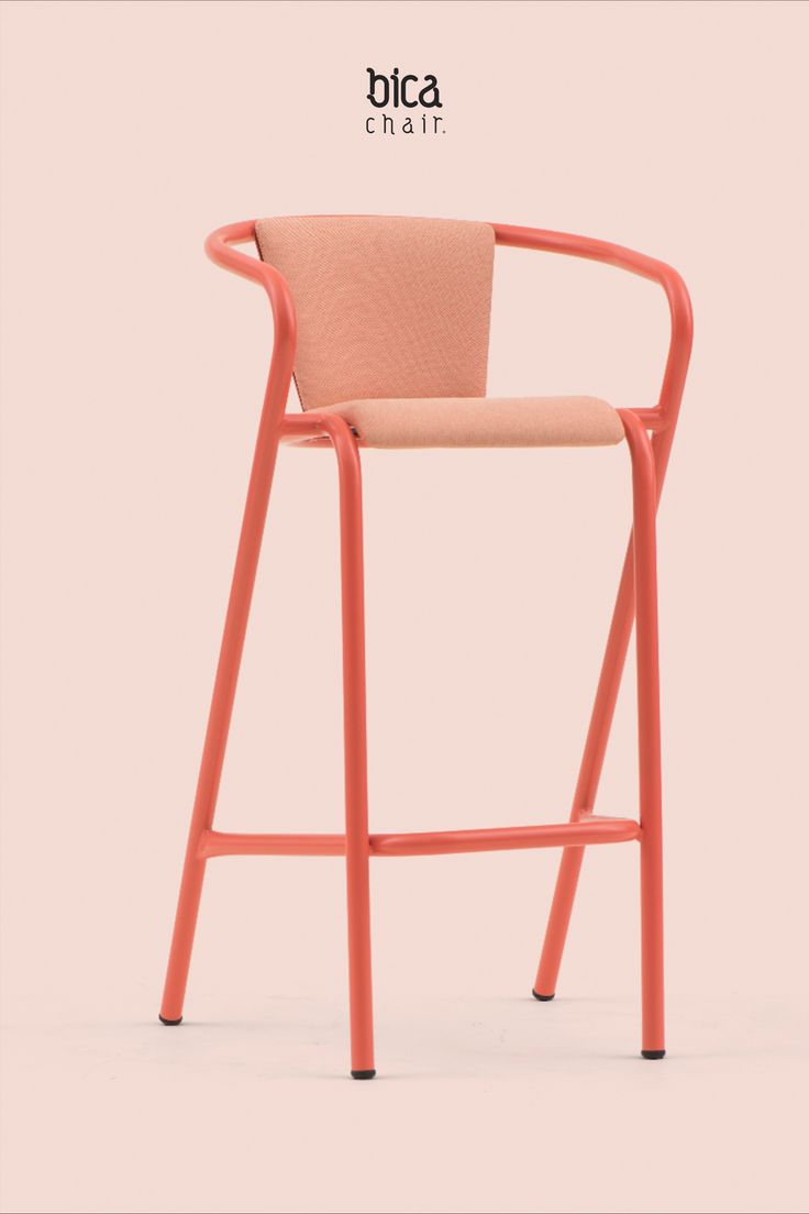 an orange chair with pink fabric on the back and arms, in front of a white background