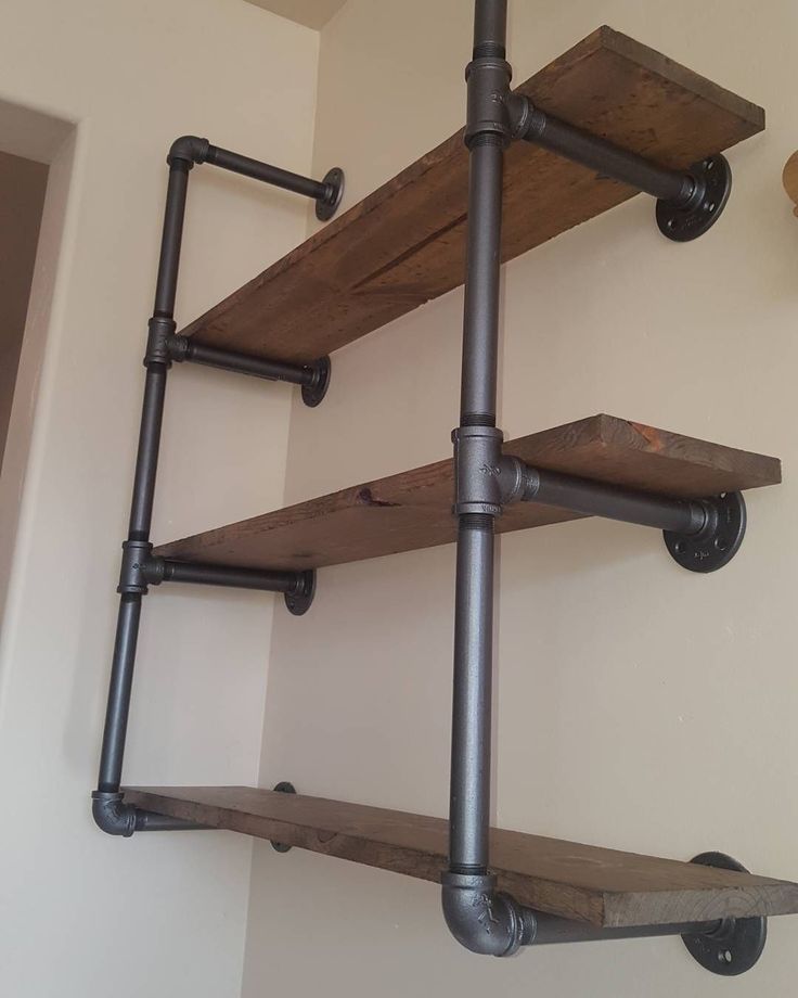 an industrial pipe and wood shelving unit