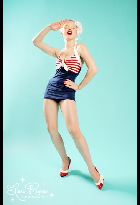 a woman posing in a bathing suit and red shoes