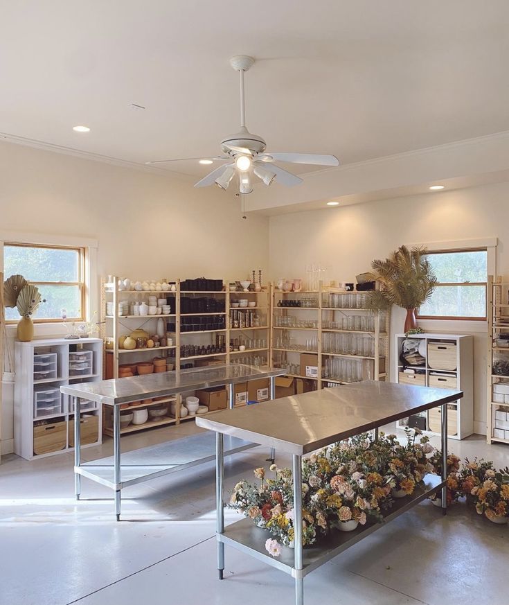 a large room with many shelves filled with flowers