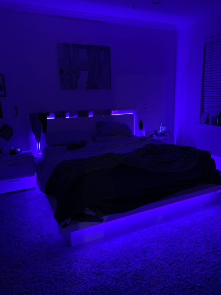 a bed in a room with purple lighting