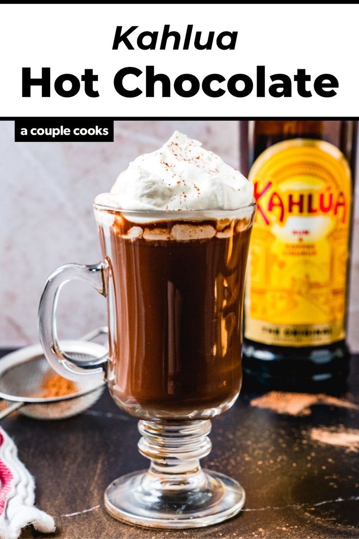 hot chocolate in a glass mug with whipped cream on top and the words kahlua hot chocolate above it