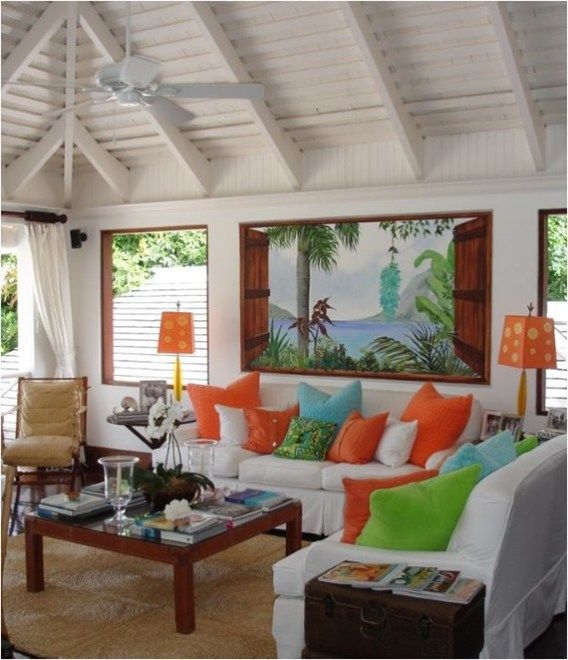 a living room filled with lots of furniture next to two windows and a painting on the wall