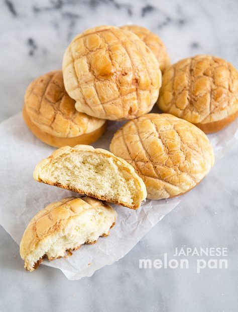 several pieces of bread sitting on top of wax paper next to some type of pastry