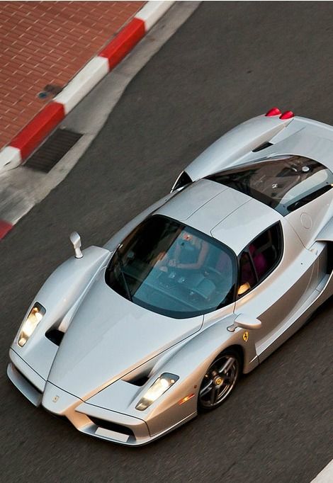 a silver sports car driving down the road