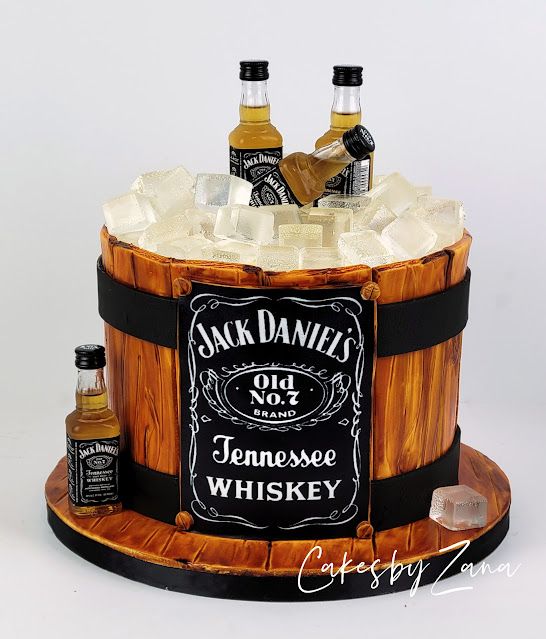 a cake made to look like a barrel with whiskey bottles on top and ice in the bottom