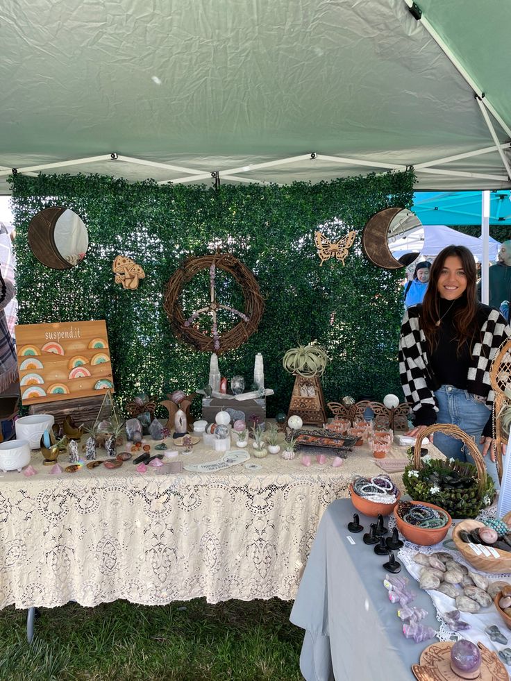 a woman standing in front of a table with food on it