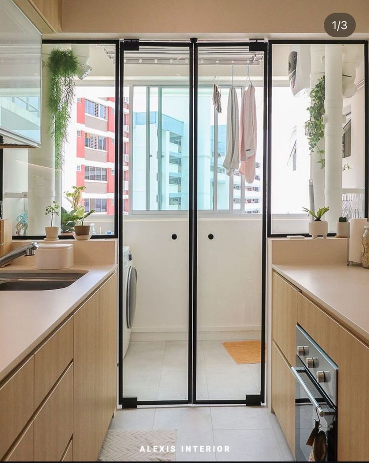 an open kitchen with sliding glass doors leading to the bathroom and laundry room in the back