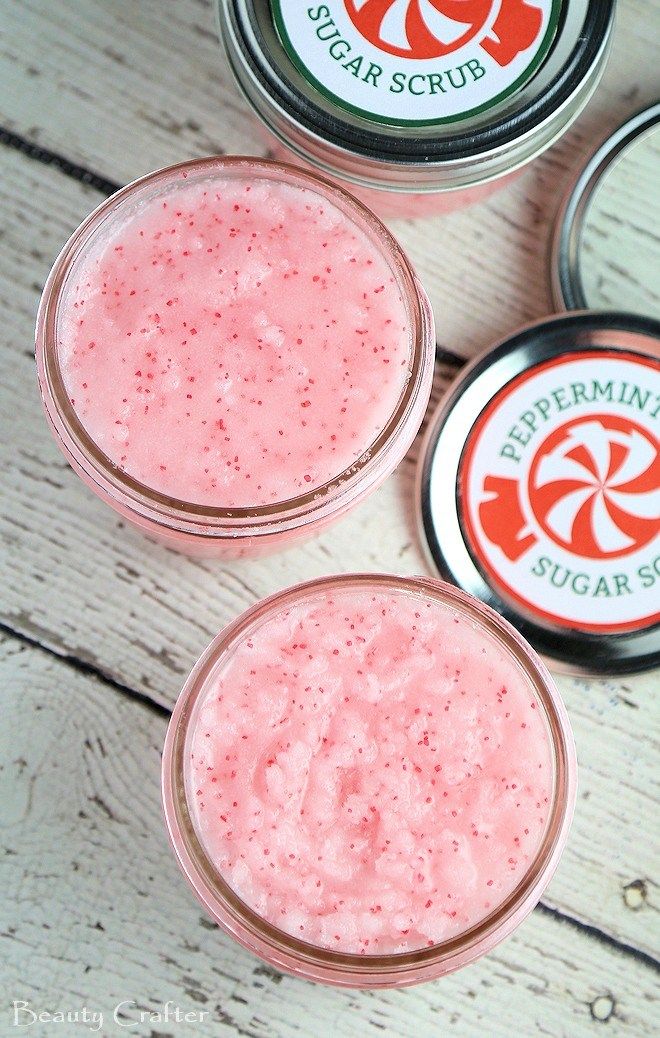 three jars filled with pink liquid sitting on top of a wooden table next to each other