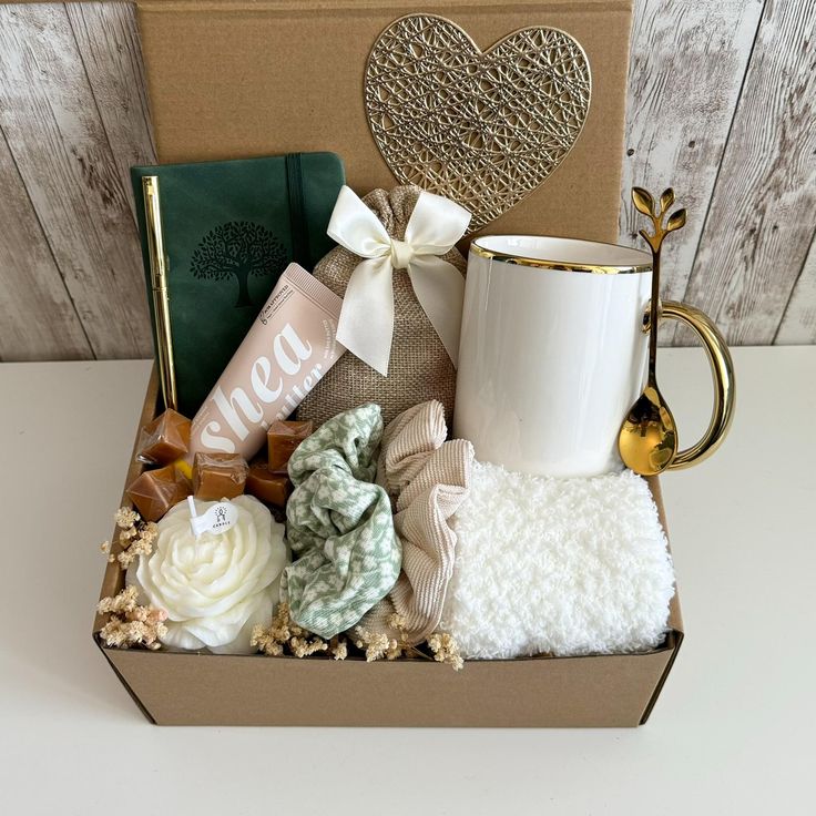 a gift box with coffee mug, blanket and other items