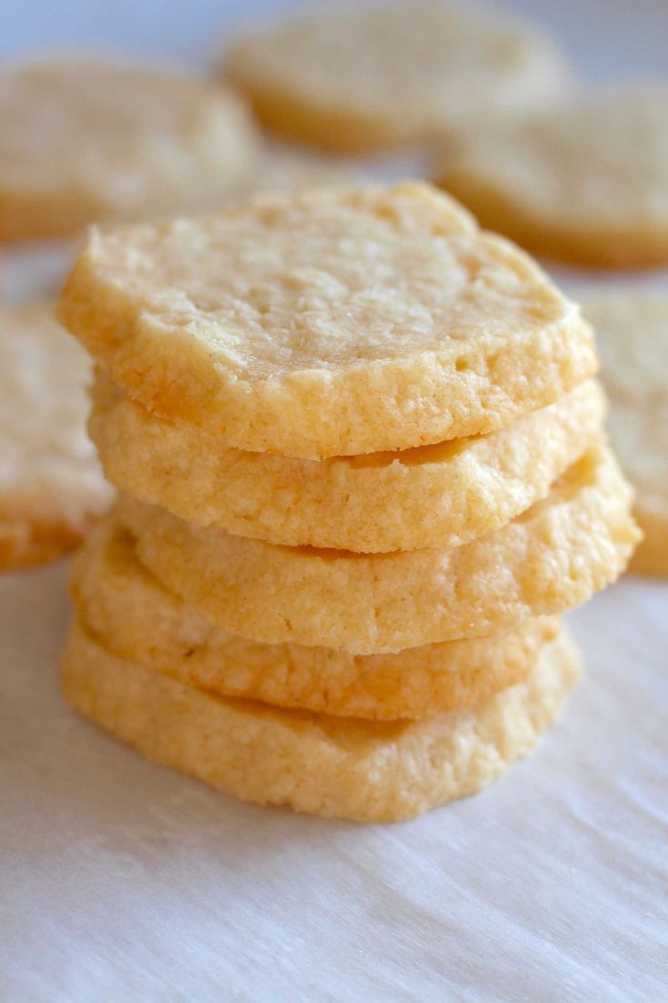 a stack of cookies sitting on top of a white tablecloth next to each other