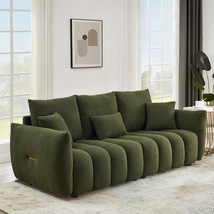 a green couch sitting on top of a white rug