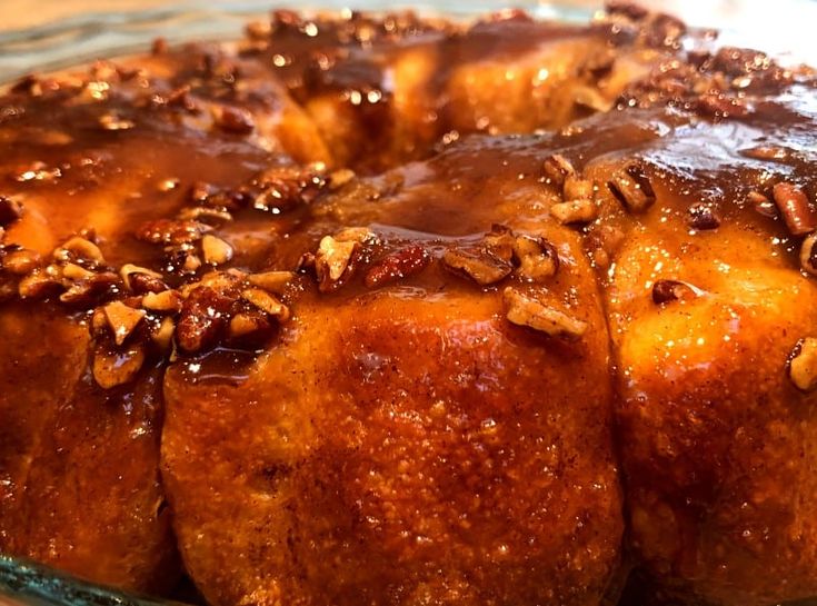 a close up of a cake with pecans on top