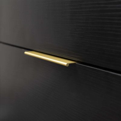 a close up view of the handles on a black cabinet with gold trimmings