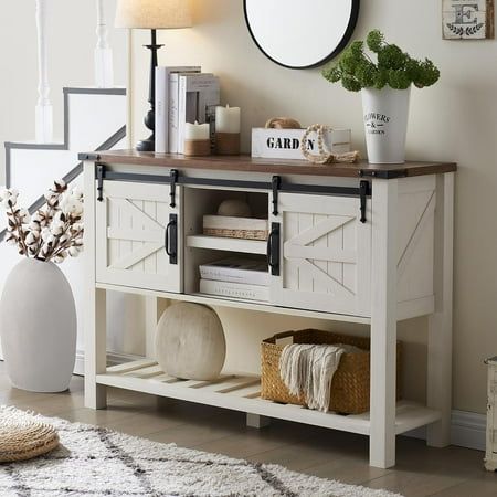 a white table topped with a mirror next to a vase