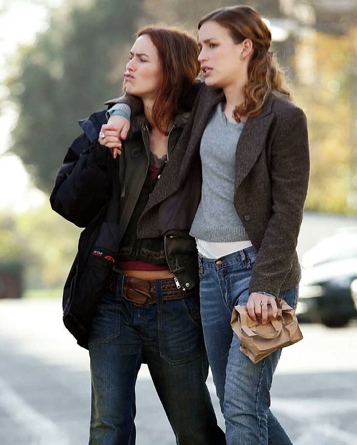 two women walking down the street talking to each other