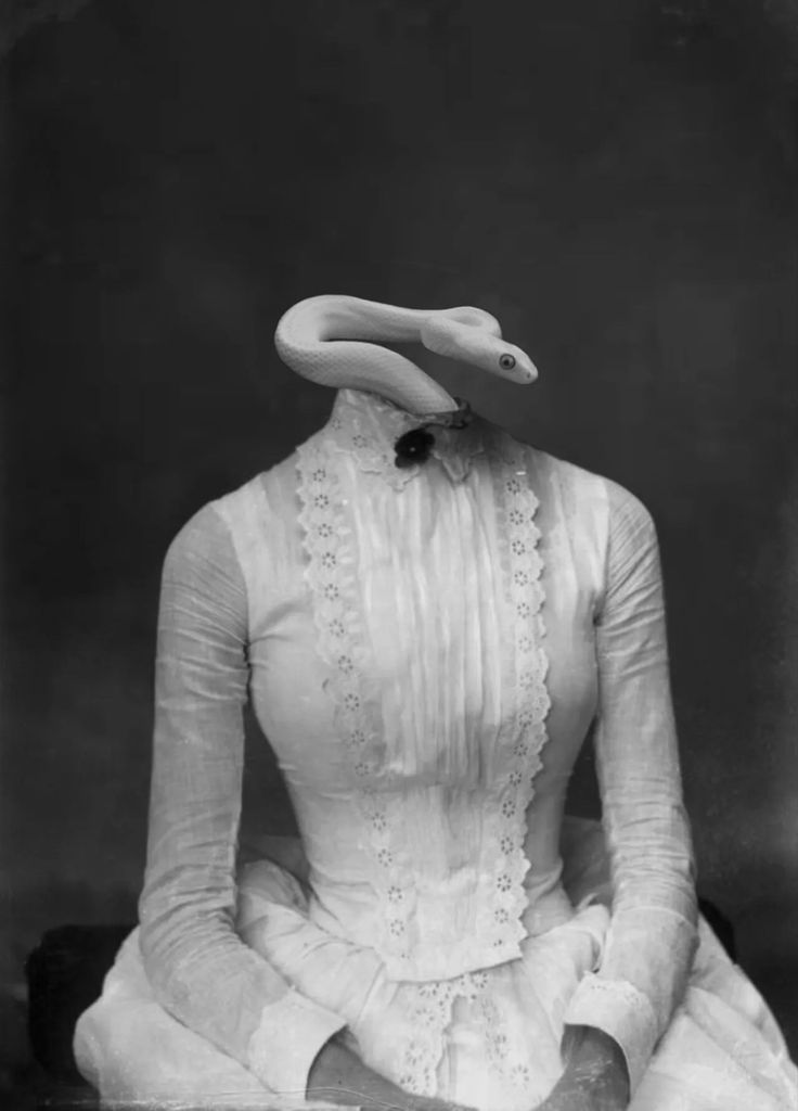 an old black and white photo of a woman in a dress with a hat on her head