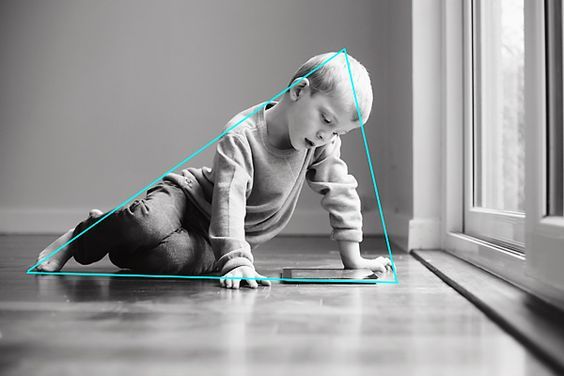 a baby is sitting on the floor with headphones in his ears and looking at something