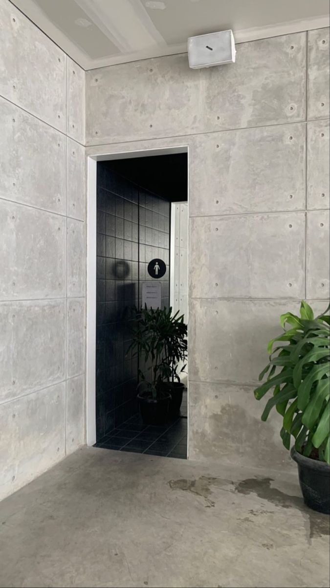 an open door leading to a bathroom with a potted plant