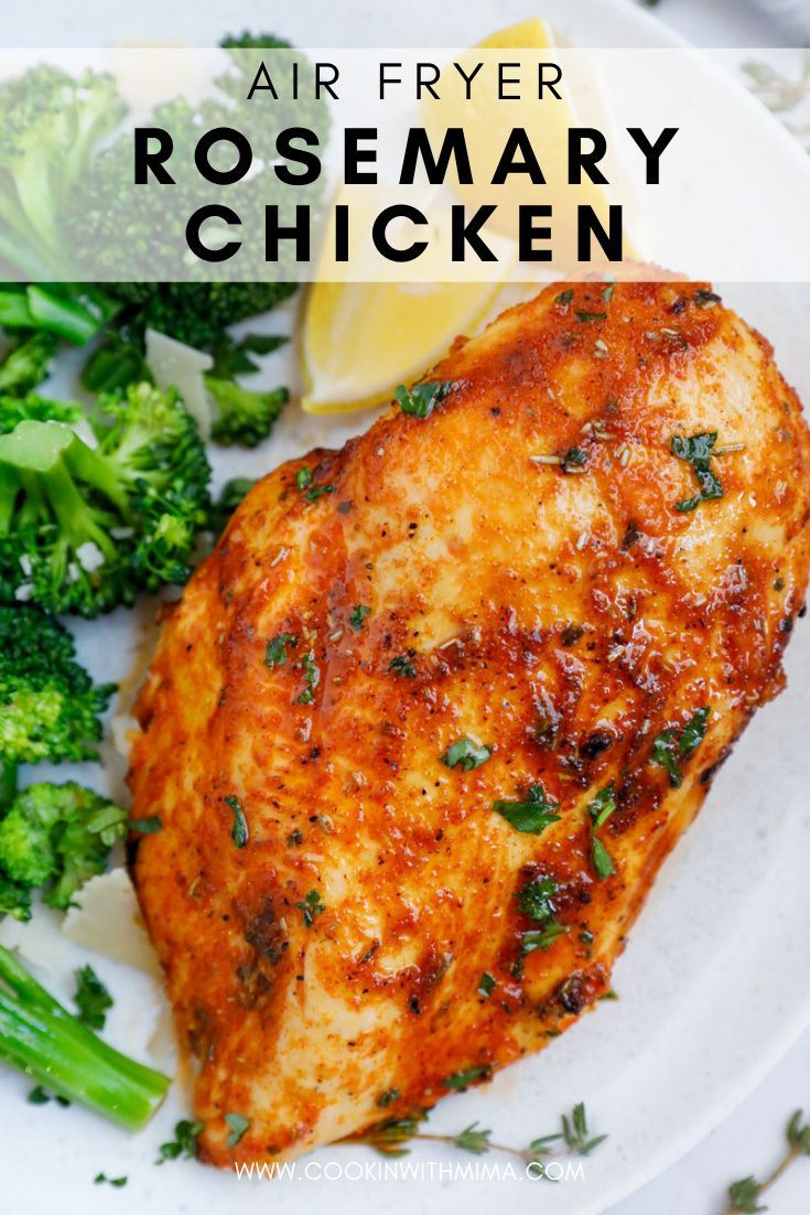 a white plate topped with chicken, broccoli and lemon wedges