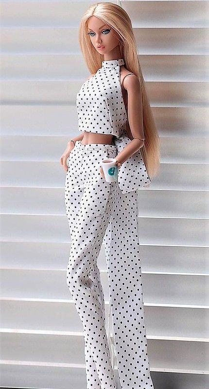 a barbie doll wearing white and black polka dot pants